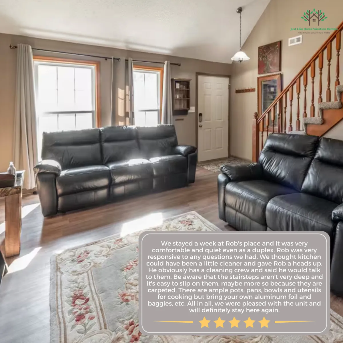 This image features black leather sofas arranged in an open living space, with a warm wooden staircase and decorative wall art in view. Soft lighting and the arrangement of furniture suggest a space ideal for relaxation, conversation, and family gatherings.